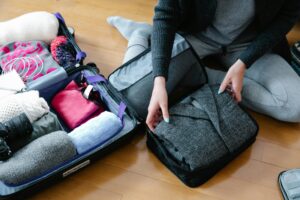 Packing essentials for solo female traveler, including shoes and backpack